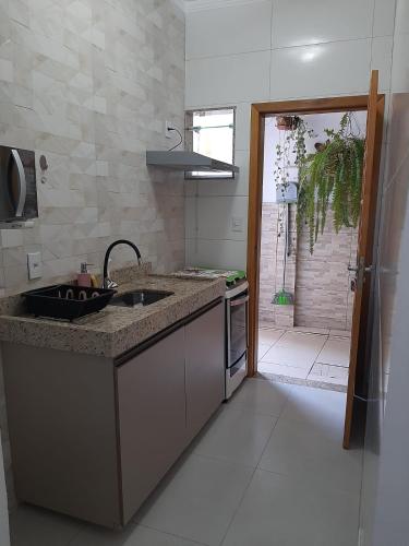 a kitchen with a sink and a counter top at Quitinete para temporada em Cabo Frio in Cabo Frio