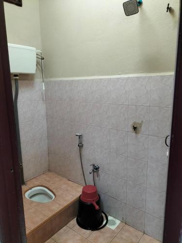 a small bathroom with a toilet in a stall at SRI TEGUH HOMESTAY in Tanah Merah