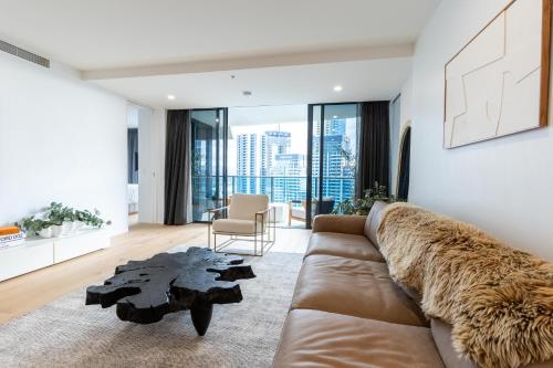 a living room with a couch and a table at Broadbeach Luxury Oracle Tower 1 Apartment 2Bed 2Bath 1 Car in Broadbeach