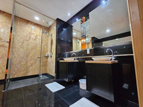a bathroom with two sinks and a shower at St Mary Residences Jalan Tengah in Kuala Lumpur