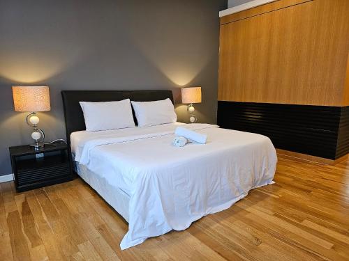 a bedroom with a bed with a book on it at St Mary Residences Jalan Tengah in Kuala Lumpur