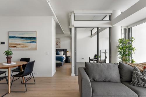 a living room with a couch and a table at Urban Rest Double Bay Apartments in Sydney