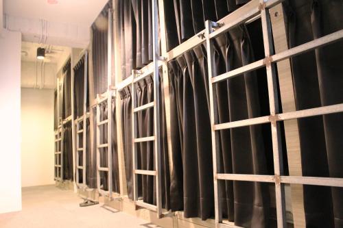 a row of black curtains in a room at miniinn in Taipei