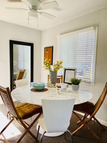a dining room with a white table and chairs at Lovely 2 bedrooms with parking in Carson in Carson