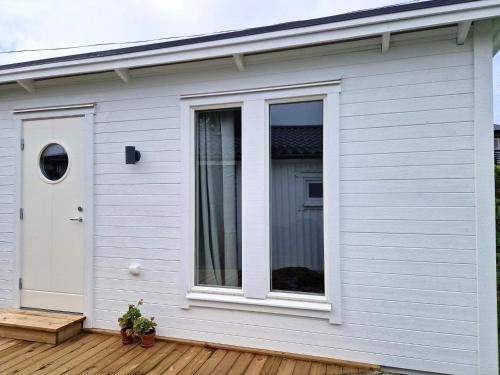 a white house with a window on a wooden deck at 4 star holiday home in SKÖVDE-By Traum in Skövde