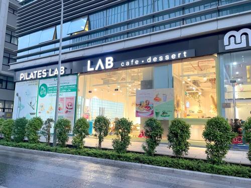 a store window with trees in front of a building at QMP - Vinhomes Metropolis in Hanoi