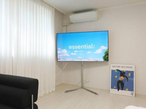 a large screen with a presentation on a wall at Stay Daewha Kintex 5min Daewha Station 5min Baek Hospital 1min in Goyang