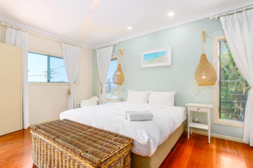 a bedroom with a large white bed and windows at Ocean View Apartments by Kingscliff Accommodation in Kingscliff