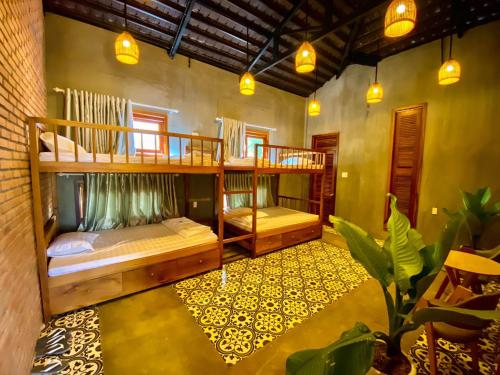 a room with two bunk beds in a house at Paksong Farmstay Gia Lai - Venuestay in Pleiku