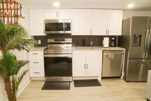 a kitchen with white cabinets and stainless steel appliances at 1 Bed 1 Bath Suite in Washington, D.C.