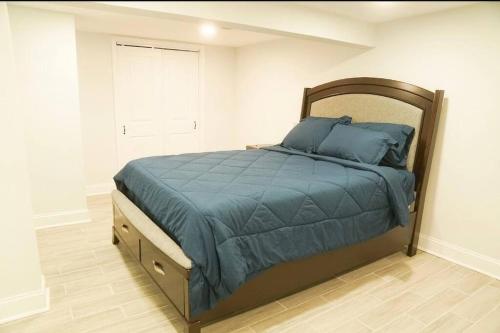 a bedroom with a bed with a blue comforter at 1 Bed 1 Bath Suite in Washington