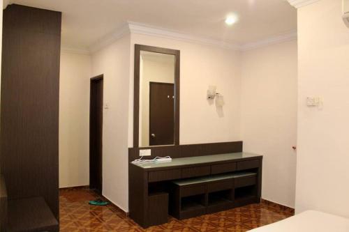 a bathroom with a sink and a mirror at D'Melor Penthouse Glory Beach Resort in Port Dickson