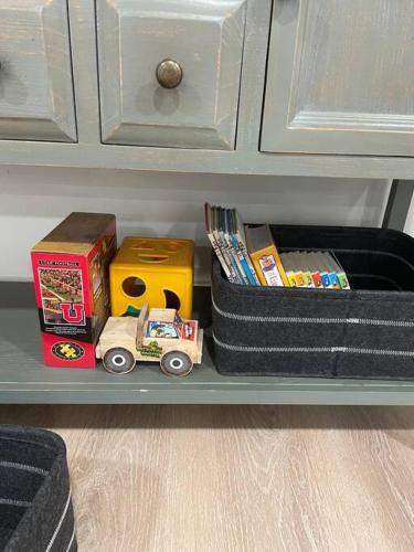 a shelf with a toy truck and boxes on it at Grace's View, full kitchen, close to skiing in Sandy