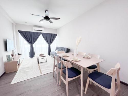 a dining room and living room with a table and chairs at Maison Signature Suites in Kuala Lumpur