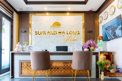 a restaurant with two chairs in front of a counter at Sunland Halong Hotel and Restaurant in Ha Long