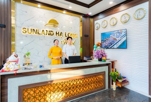 a lobby with a large fireplace and a poster on the wall at Sunland Halong Hotel and Restaurant in Ha Long