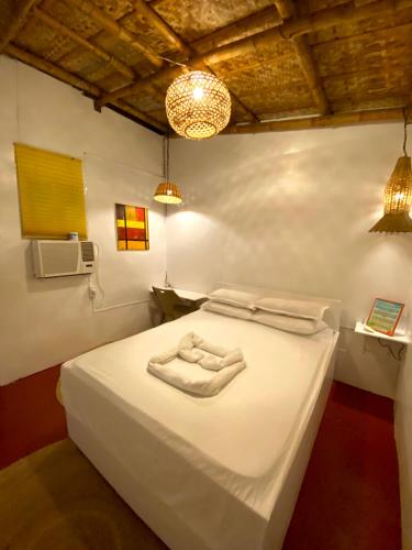 Tibiao的住宿－Kasa Raya Inn，一间卧室配有一张床,上面有两条毛巾