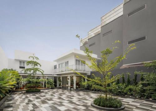 a courtyard of a building with a tree in the middle at No303 in Bandung