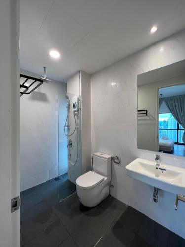 a bathroom with a toilet and a sink and a shower at Reizz Residence By Classy in Kuala Lumpur