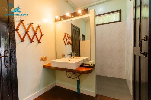 a bathroom with a sink and a mirror at Koh Rong Hill Beach Resort in Koh Rong Island