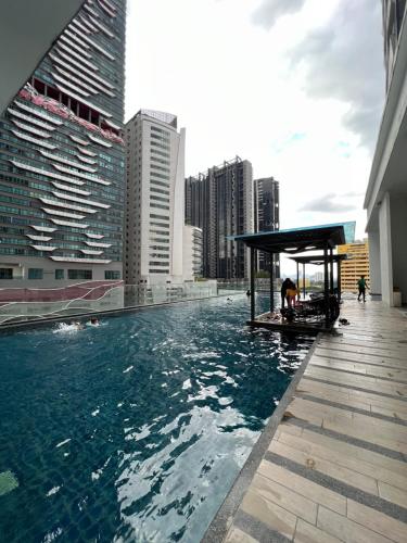 a swimming pool on the roof of a building at Reizz Residence By Classy in Kuala Lumpur