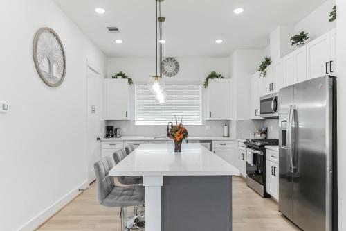 a kitchen with a white counter and a refrigerator at Dream suite in downtown in Houston