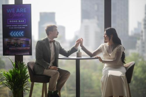 a man and woman sitting at a table holding hands at ibis Styles Bangkok Silom in Bangkok