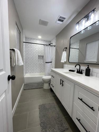 a bathroom with a sink and a toilet and a mirror at Apt 5 - High Plains Lodge at Nomad Landing in Clayton