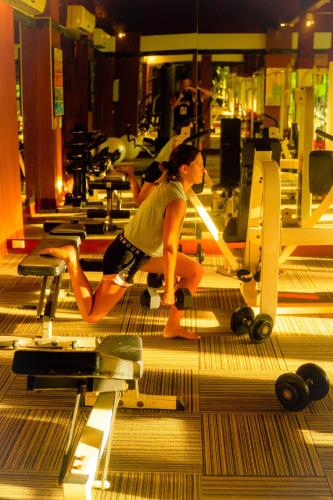 a woman sitting on a bench in a gym at Twin Lotus Resort and Spa - SHA Plus - Adult Only "November - April" in Ko Lanta