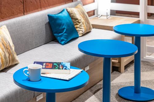 神戶的住宿－the b kobe，客厅设有两张蓝色的桌子和一张沙发