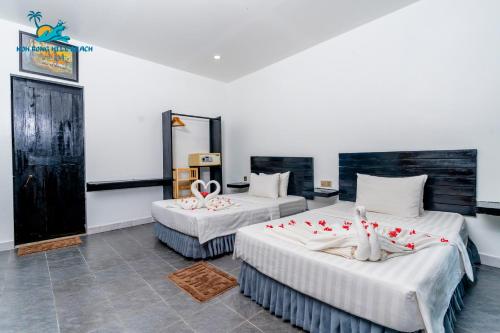 two beds in a room with red and white decorations on them at Koh Rong Hill Beach Resort in Koh Rong Island