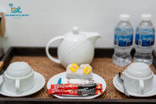 a table with a tea pot and plates and water bottles at Koh Rong Hill Beach Resort in Koh Rong Island
