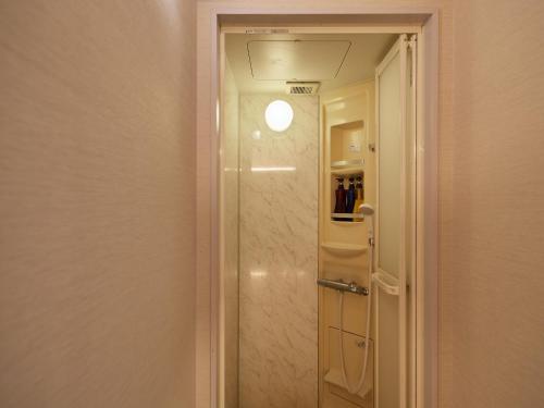 a bathroom with a shower with a glass door at Wind City Hotel in Tahara