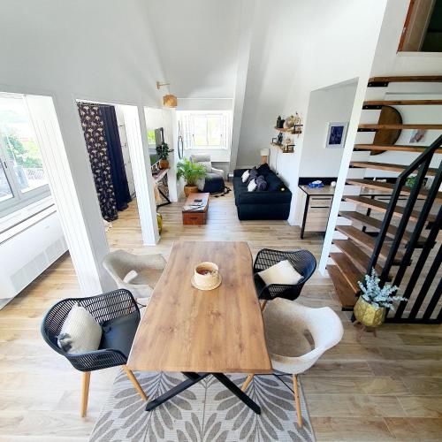 a living room with a wooden table and chairs at Appart Angel in Saint-Benoît