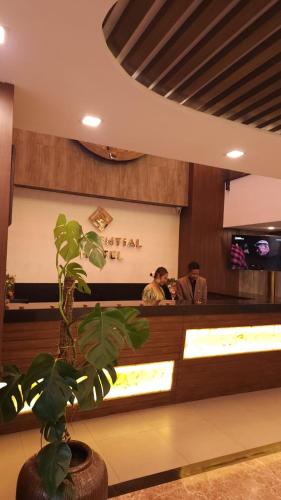 two people sitting at a counter in a restaurant at Prudential Hotel Nepal in Kathmandu