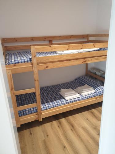 a wooden bunk bed in a room at Ático Montblanc Zona Baja in Sierra Nevada