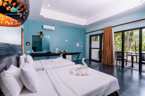 two beds in a room with blue walls at Koh Rong Hill Beach Resort in Koh Rong Island