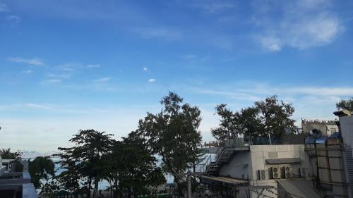 a view of a city with trees and buildings at Big Boys' Bed & Burger - Patong Beach in Patong Beach