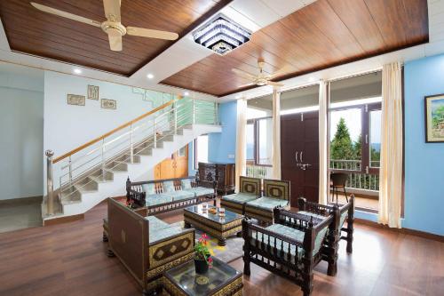 a living room with a staircase and a couch at Morning Bliss by VEO - Part of StayVista in Rānīkhet