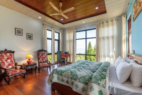 a bedroom with a bed and a large window at Morning Bliss wih Bonfire at Ranikhet by StayVista in Rānīkhet