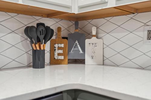 a kitchen counter with knives and utensils on a shelf at Spacious 4BR Retreat in Vibrant Smyrna Near Lakes in Smyrna