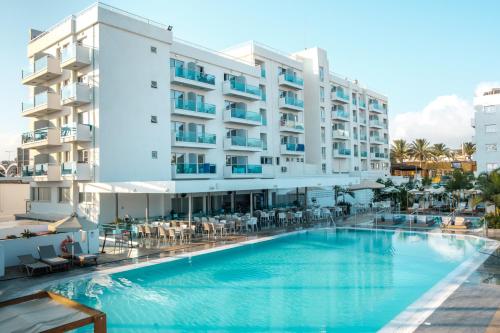 a swimming pool in front of a hotel at Kapetanios Bay Hotel Protaras in Protaras