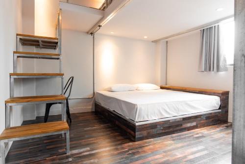 Un dormitorio con una cama y estanterías. en miniinn, en Taipéi