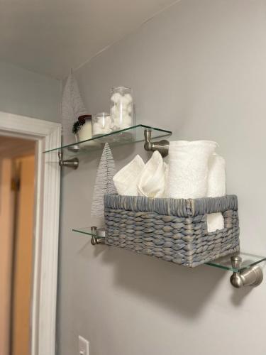 a bathroom with a basket of towels on a wall at Cargo7 Cozy suites2 in North Providence