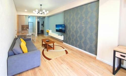 a living room with a couch and a tv at Arbat apartment in the center city in Bishkek