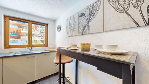 a kitchen with a counter and a sink at No 8 Bed & Bar in Verbier