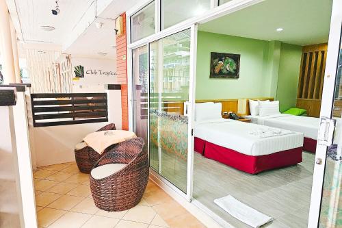 a hotel room with two beds and a balcony at Dome Resort SHA Plus in Kata Beach