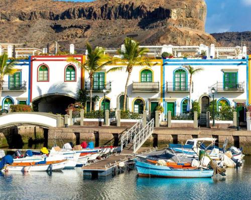 a group of boats are docked in a harbor at FABULOUS BUNGALOW , WIFI, SWIMMING POOL AND BEACH in Pasito Blanco