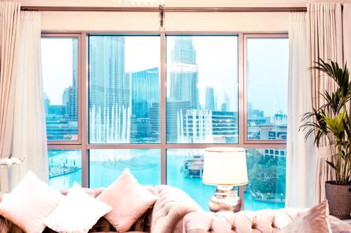 a living room with a couch and a large window at Elite Royal Apartment - Full Burj Khalifa & Fountain view - Opal - 2 bedrooms plus 1 open bedroom without partition in Dubai