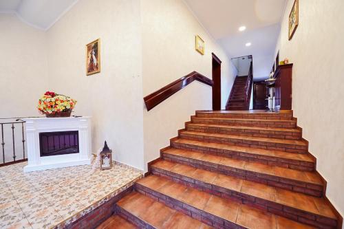 a staircase in a home with a fireplace at Conacul Domnesc in Suceava